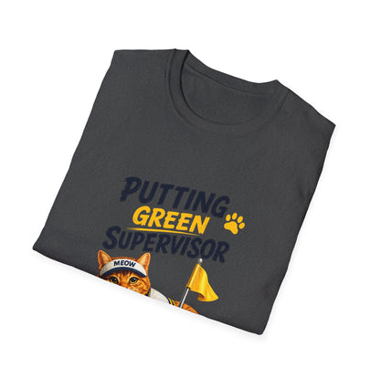 An dark heather folded t-shirt with a graphic print that reads 'PUTTING GREEN SUPERVISOR' in navy and yellow, featuring an orange tabby cat wearing a 'MEOW' cap and holding a yellow flag.