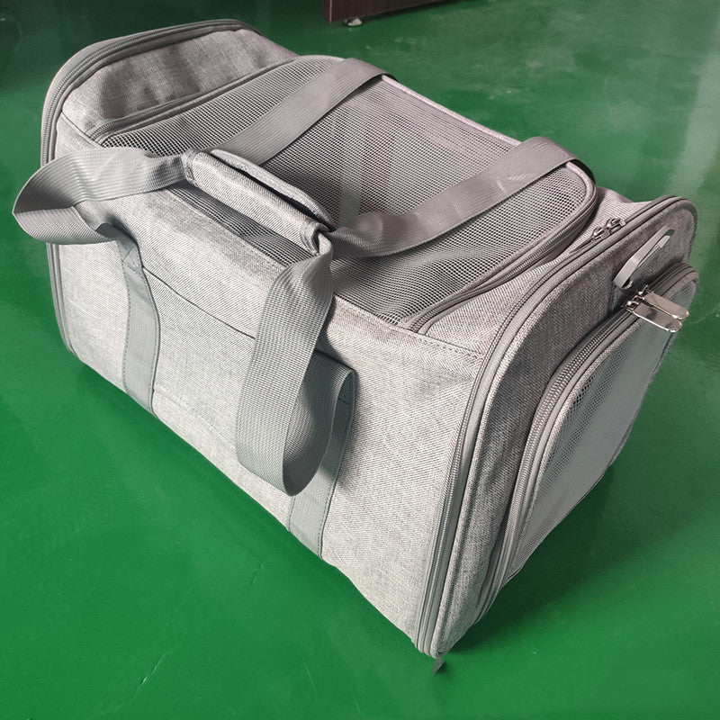 Gray duffel bag on a green surface