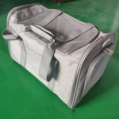 Gray duffel bag on a green surface
