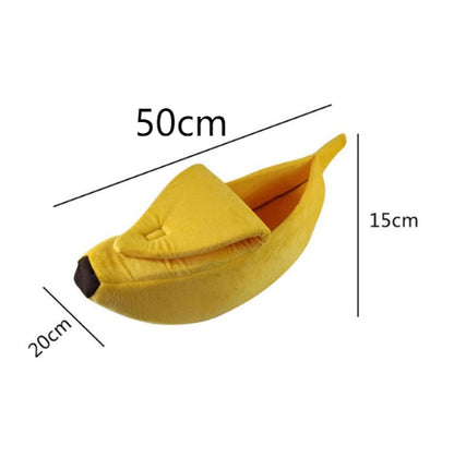 Yellow banana-shaped pet bed with measurements on a white background