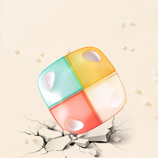 Colorful pill organizer with a cracked surface on a beige background