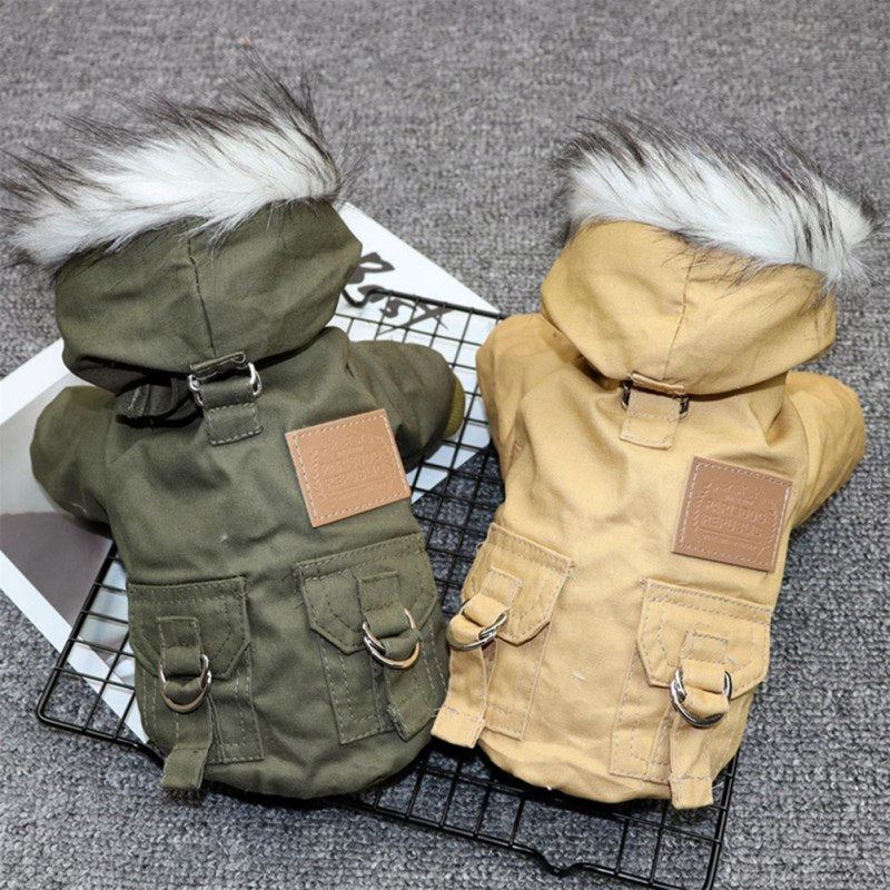Two dog coats, one green and one beige, on a wire rack with a textured gray background.