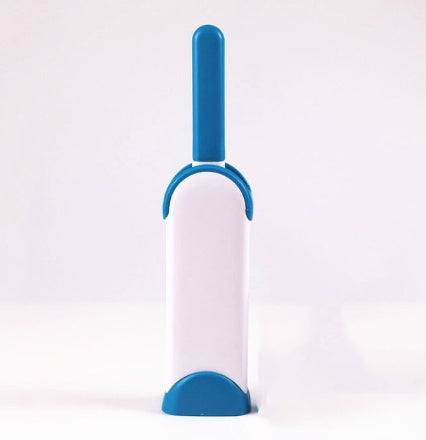 White and blue pet grooming brush on a white background