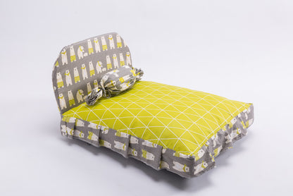 Dog bed with gray and yellow pattern on a white background