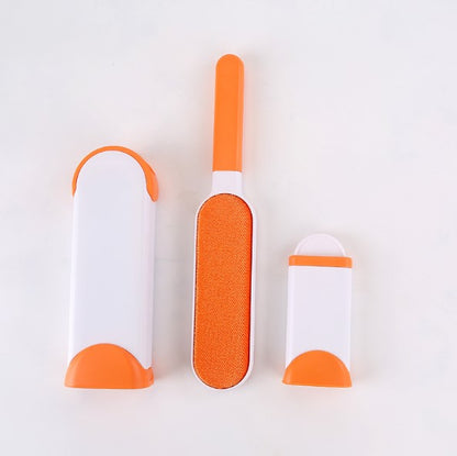 Three grooming tools with orange and white design on a light gray background