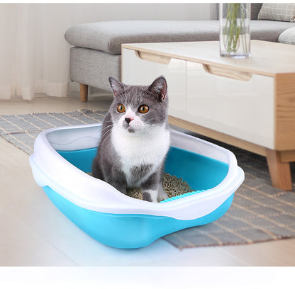 Cat using a blue and white litter box in a living room setting.