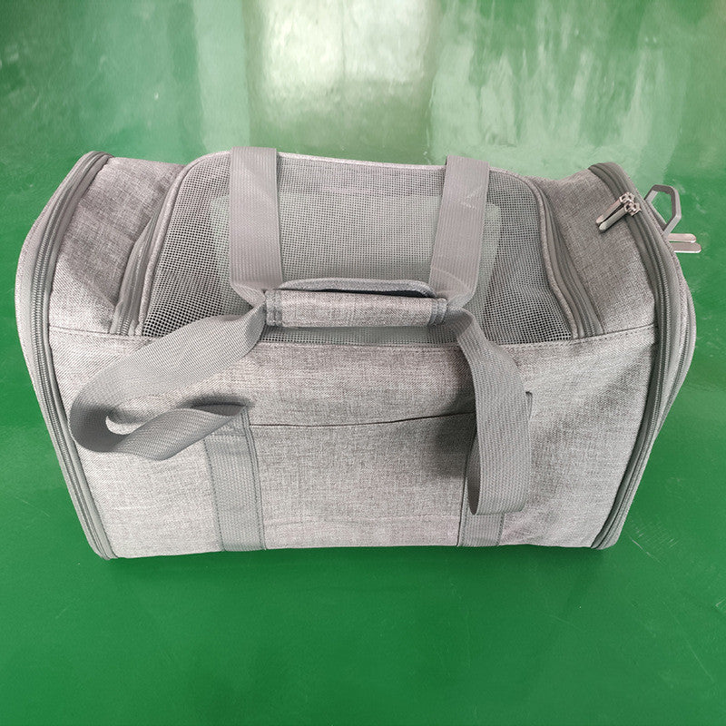 Gray duffel bag on a green surface