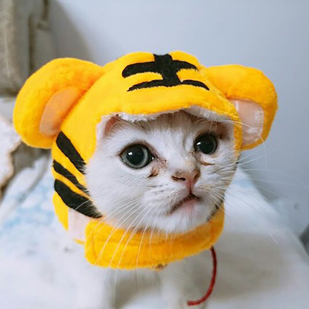Cat wearing a yellow tiger-striped hat with black accents.