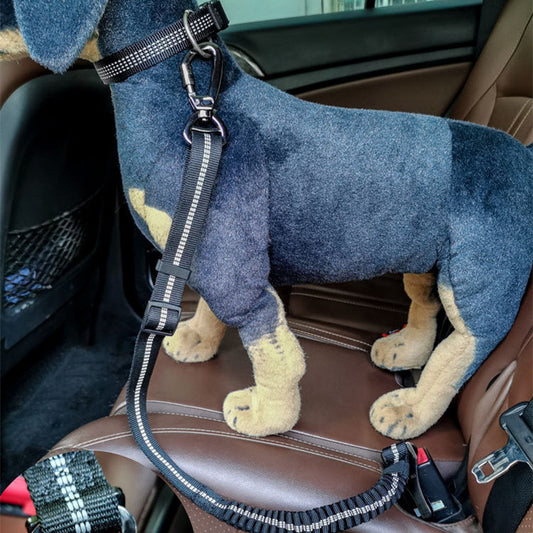 Dog toy resembling a dachshund sitting on a car seat with a leash attached.