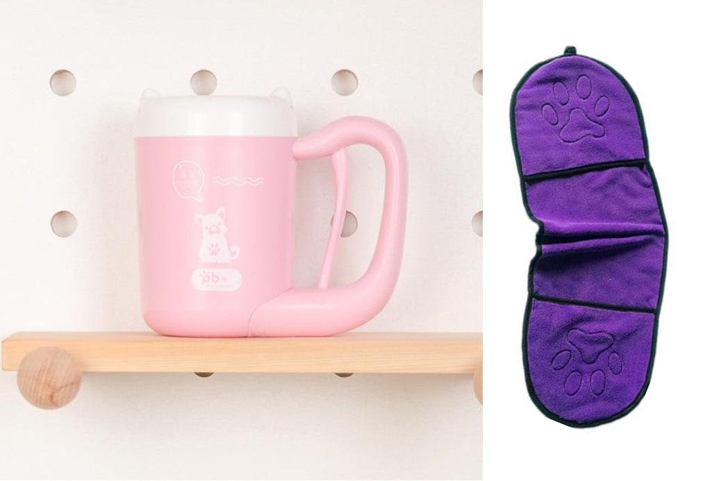 Pink mug on a wooden shelf with a purple paw-patterned item next to it.