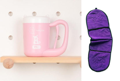 Pink mug on a wooden shelf with a purple paw-patterned item next to it.
