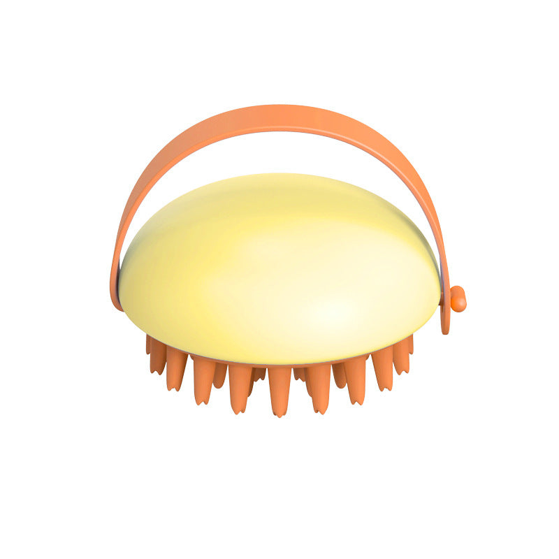 Yellow scalp massager with orange handle on a white background