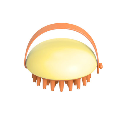 Yellow scalp massager with orange handle on a white background