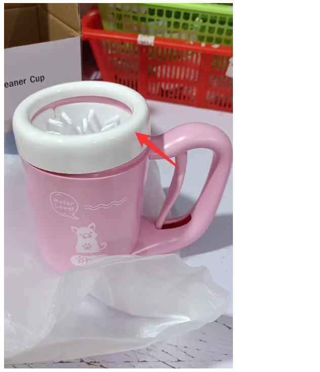 Pink cleaning cup with a white lid on a white surface, with a red arrow pointing to the lid.