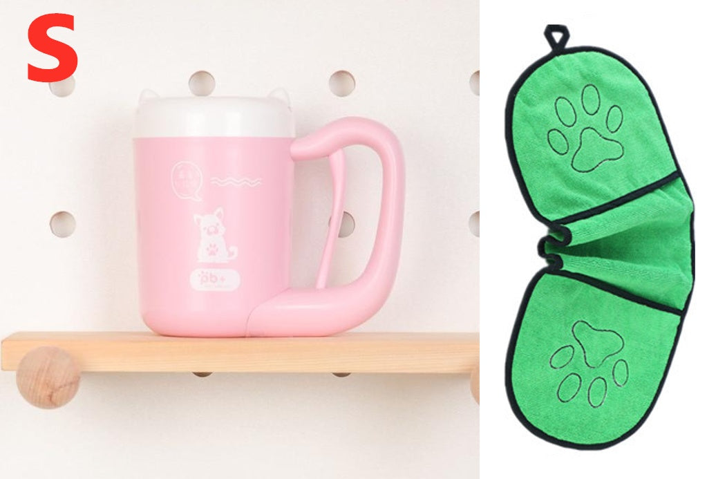 Pink mug on a wooden shelf with a green paw print oven mitt next to it.