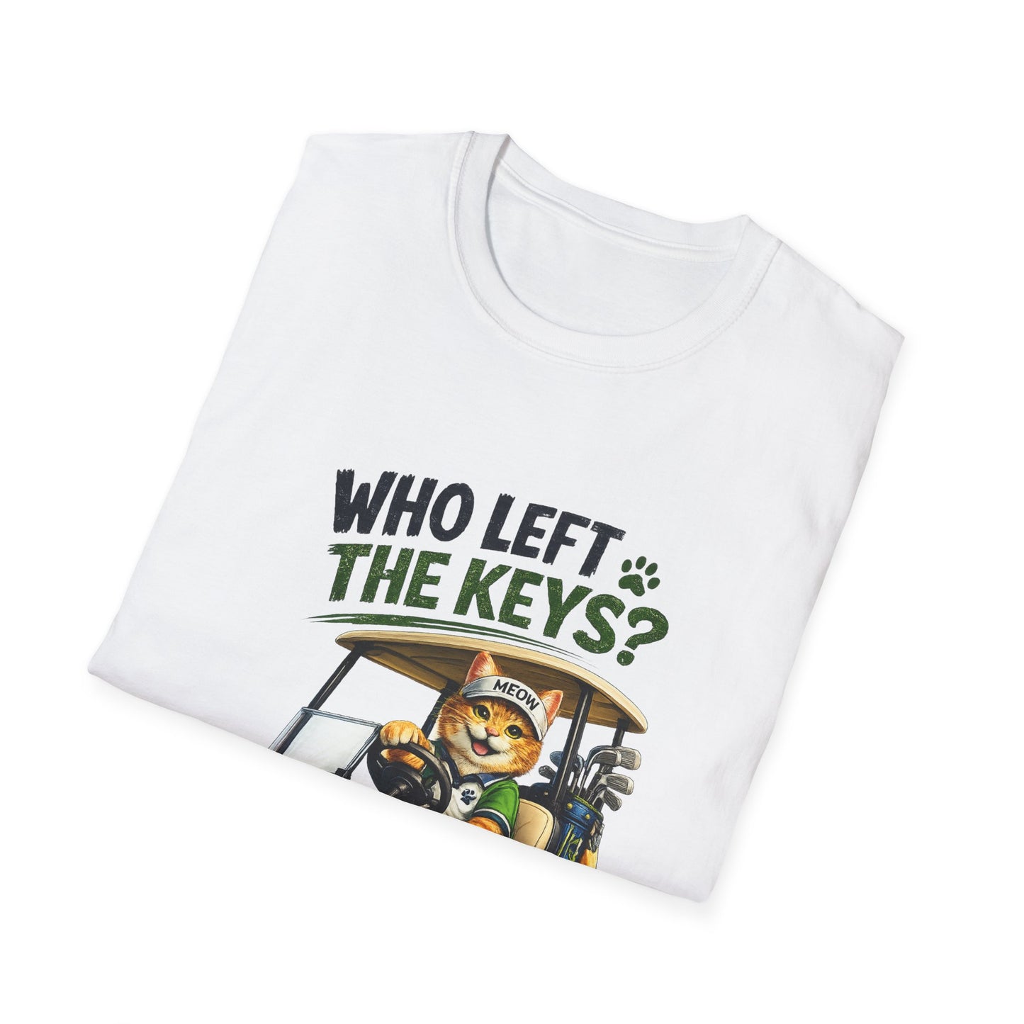A folded white t-shirt with a graphic print on the front. The graphic features the text 'WHO LEFT THE KEYS?' in black and green, above an illustration of a cartoon cat wearing a golf hat and holding golf clubs in a golf cart.