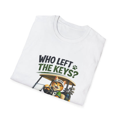 A folded white t-shirt with a graphic print on the front. The graphic features the text 'WHO LEFT THE KEYS?' in black and green, above an illustration of a cartoon cat wearing a golf hat and holding golf clubs in a golf cart.
