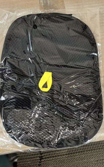 Black bag with a yellow tag on a clear plastic sheet