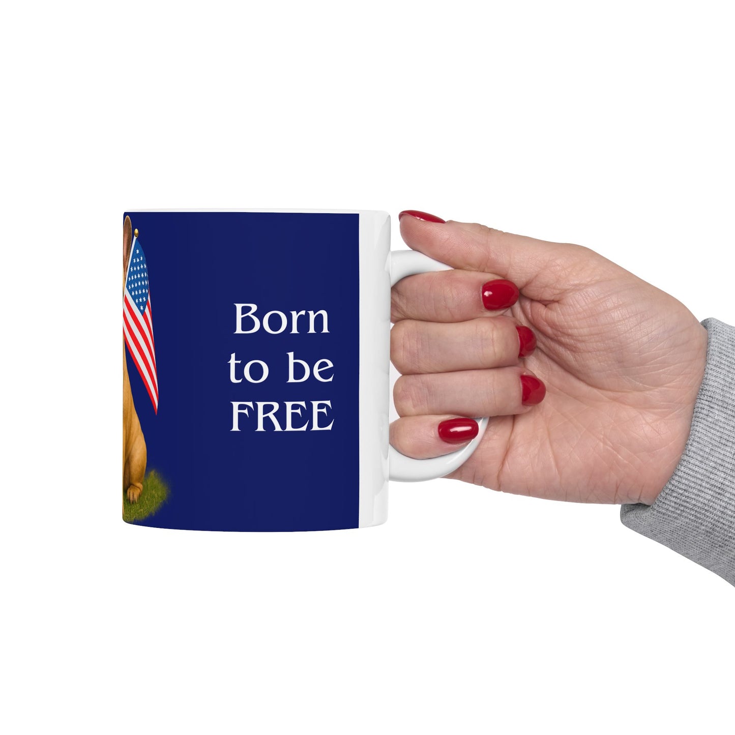 Mug with 'Born to be FREE' text and an American flag, held by a hand.