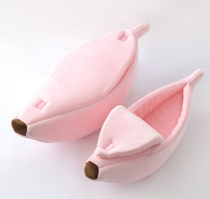 Pink banana-shaped pet beds on a light gray background