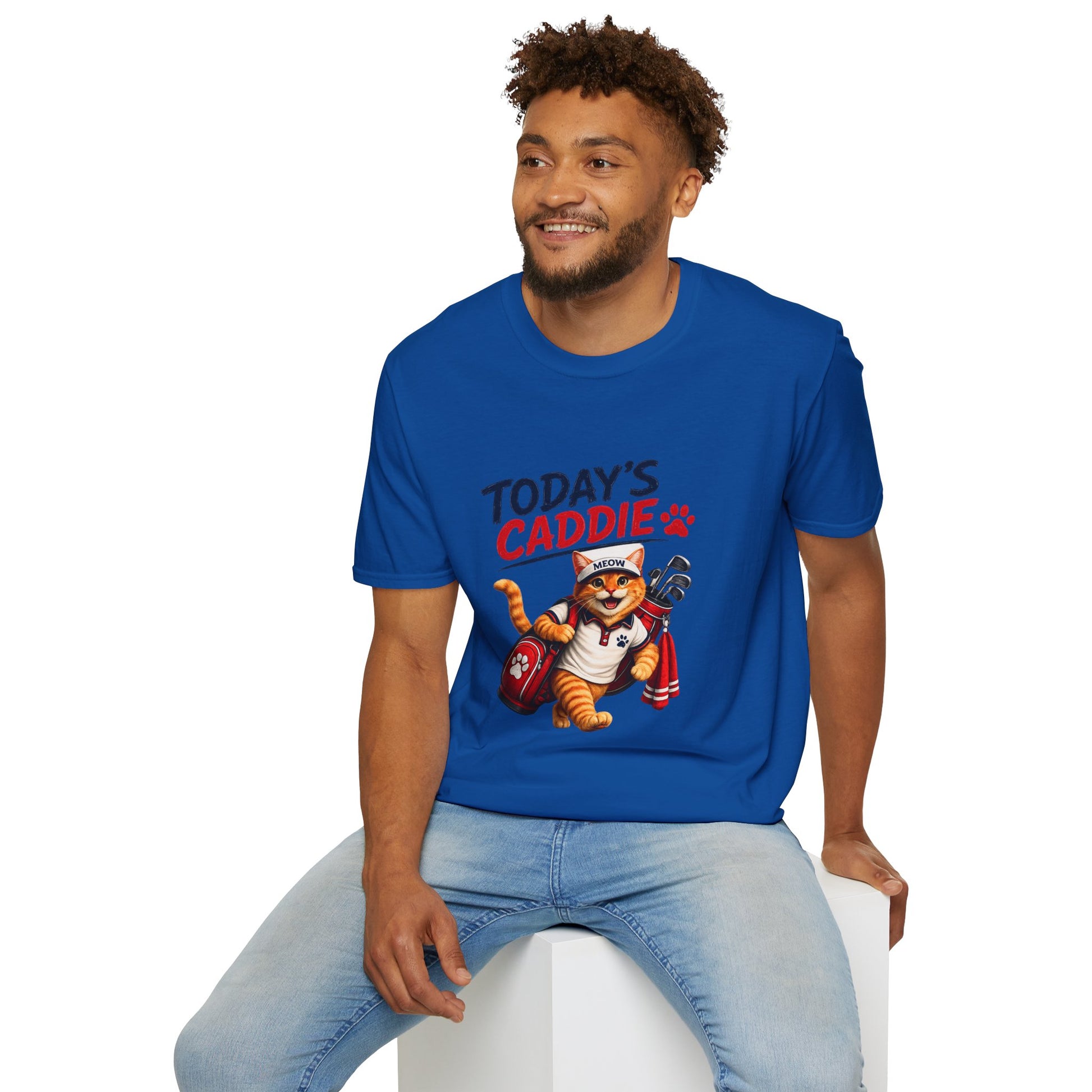 An royal blue short-sleeve crewneck t-shirt featuring a cartoon graphic of an orange tabby cat wearing a cap and holding golf clubs, with the text 'TODAY'S CADDIE' 