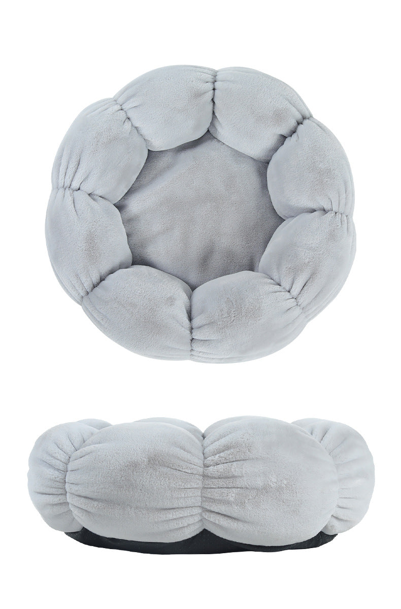 Gray plush ball with a textured surface on a white background