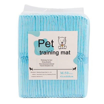 Packaged blue pet training mat with a label on a white background