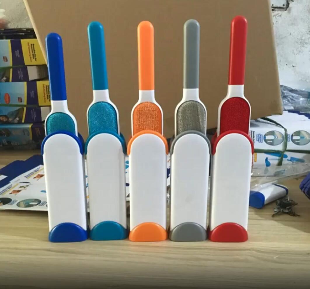 Set of colorful pet grooming brushes on a wooden surface.