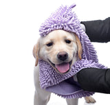 Dog wrapped in a purple towel with a white background