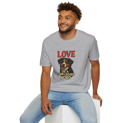 Man wearing a gray t-shirt with a graphic design and text, sitting on a white stool against a white background.