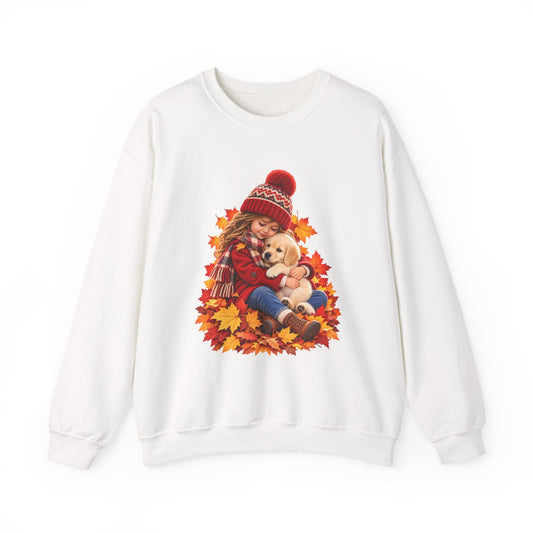 White crewneck sweatshirt featuring a little girl cuddling a golden retriever puppy among autumn leaves
