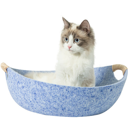 Cat sitting in a blue pet hammock on a white background