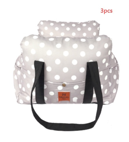 White polka dot bag with black straps on a white background
