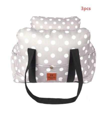 White polka dot bag with black straps on a white background