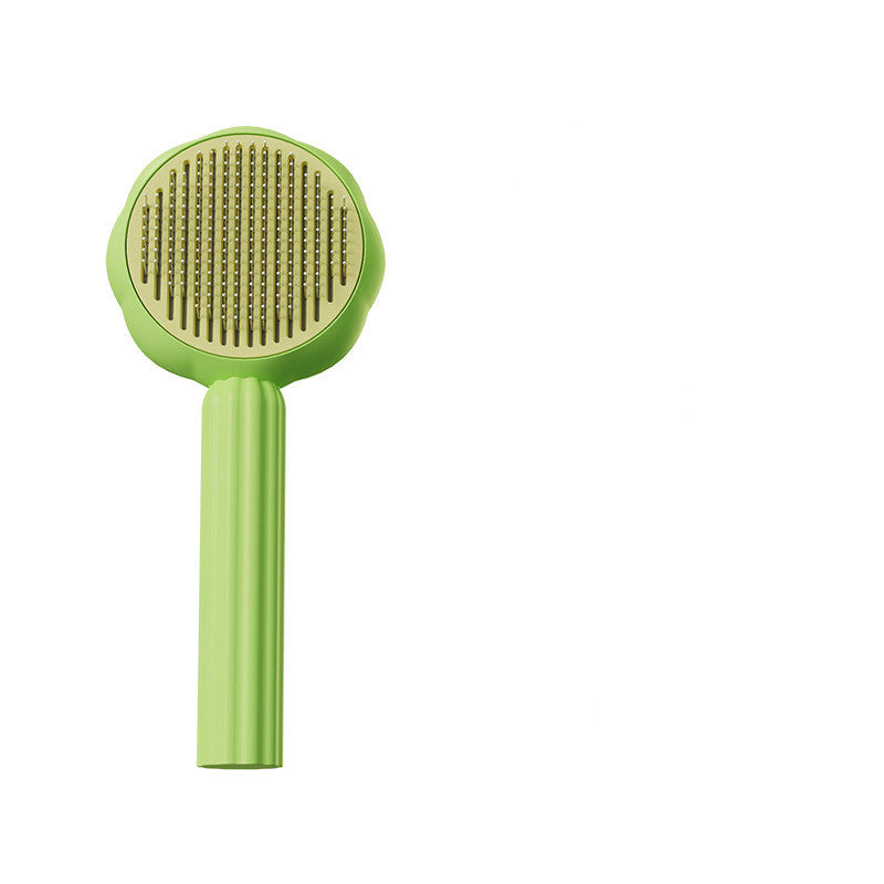 Green pet grooming brush on a white background