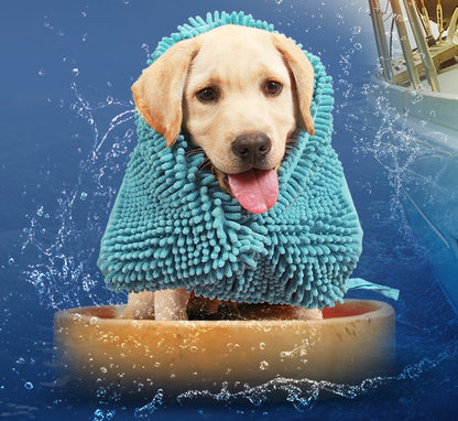 Dog wearing a blue towel after a bath in water with splashes