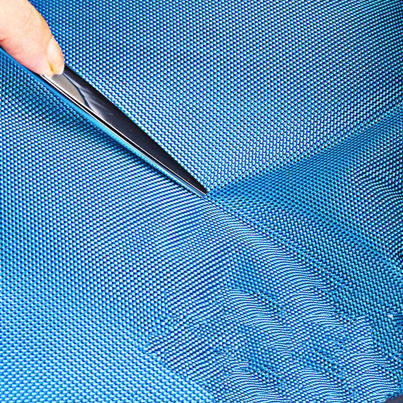 Metallic tool being used on a blue textured surface