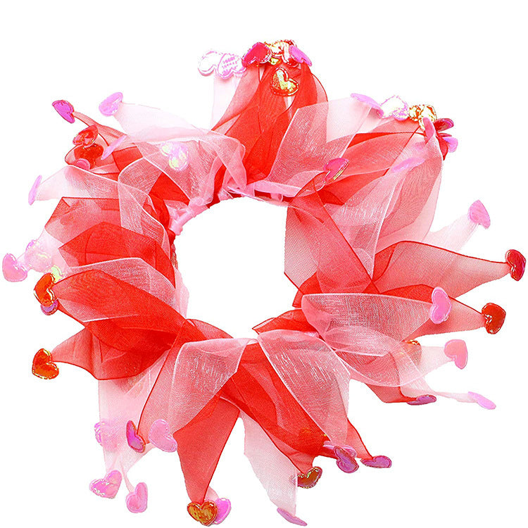 Decorative wreath with red and pink ribbons on a white background