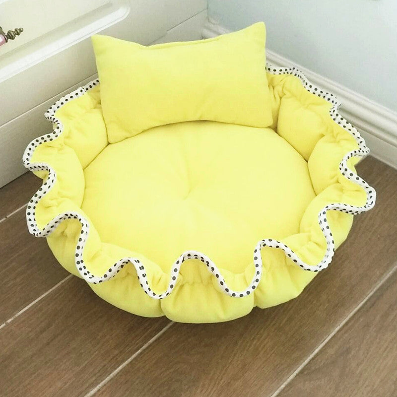 Yellow pet bed with a pillow on a wooden floor