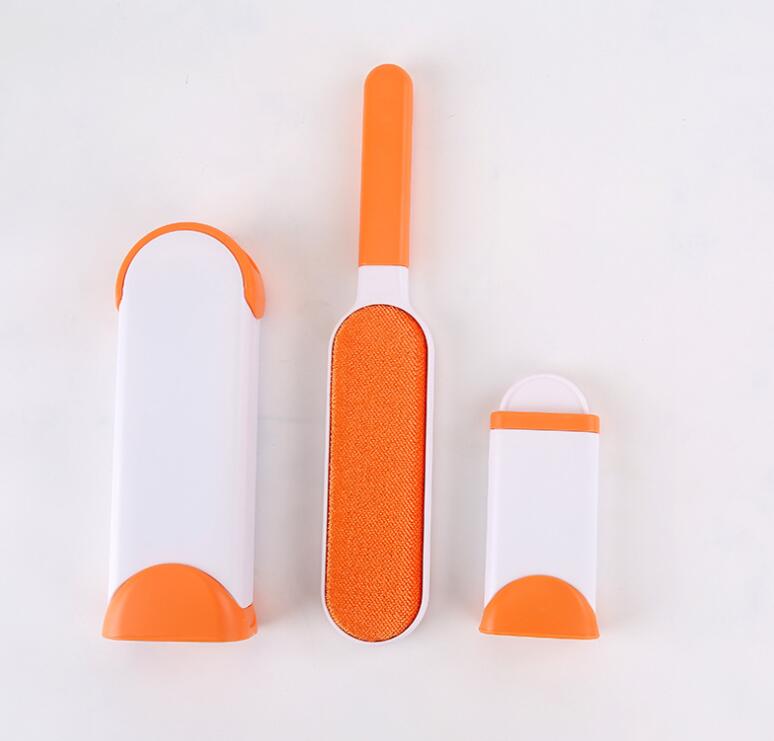 Three orange and white grooming tools on a light gray background