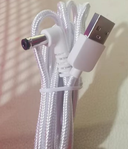 Close-up of a braided USB cable with connectors on a neutral background