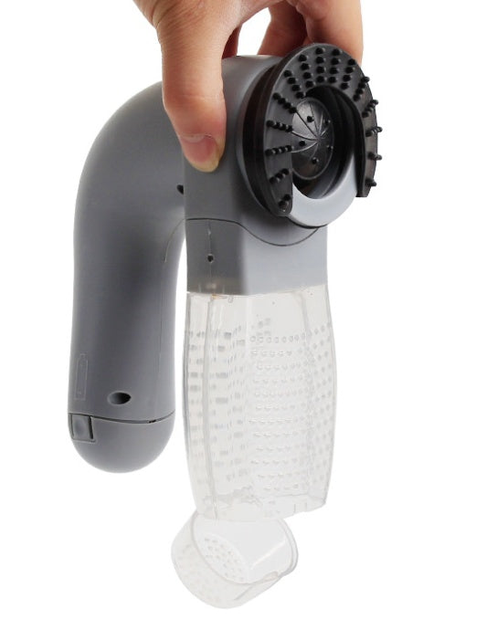 Handheld grooming tool with a clear plastic base and gray handle, held by a hand on a white background.