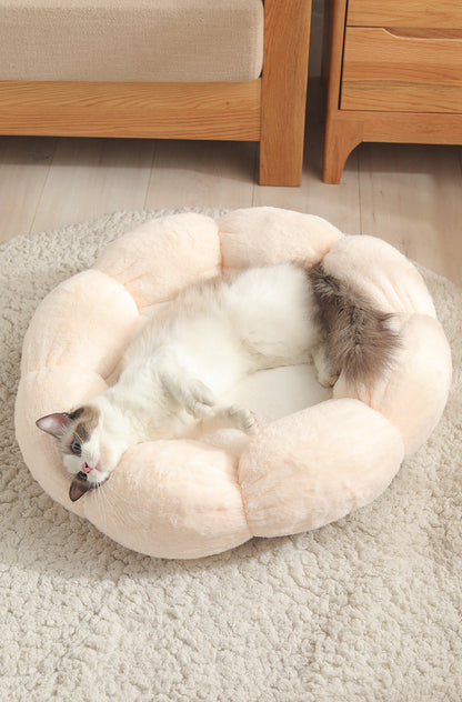 Cat lying on a fluffy pet bed in a cozy room with wooden furniture.