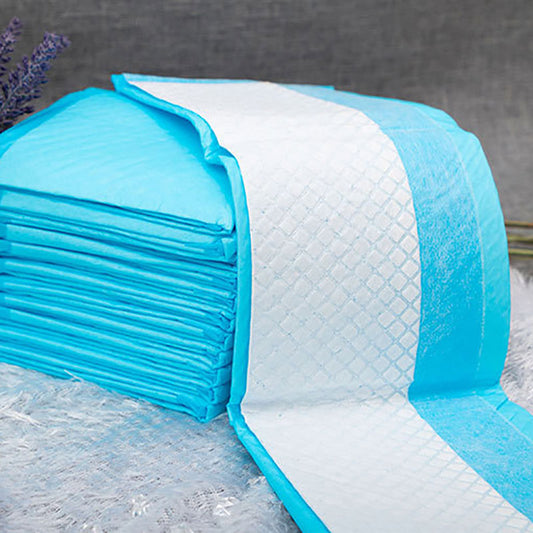 Stack of blue and white quilted mattress toppers on a textured surface.