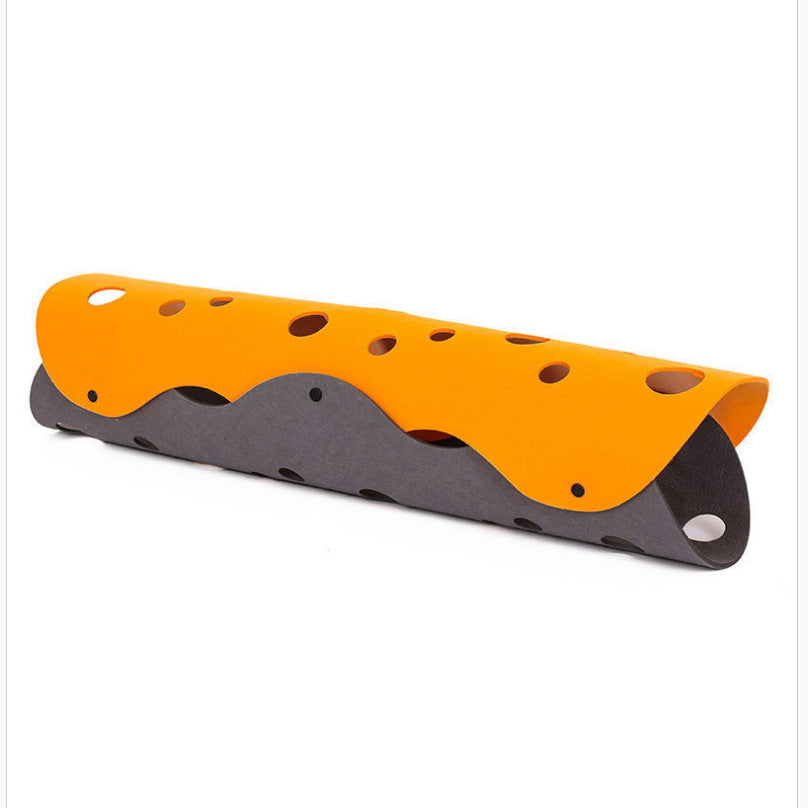 Orange and gray plastic object with multiple holes on a white background