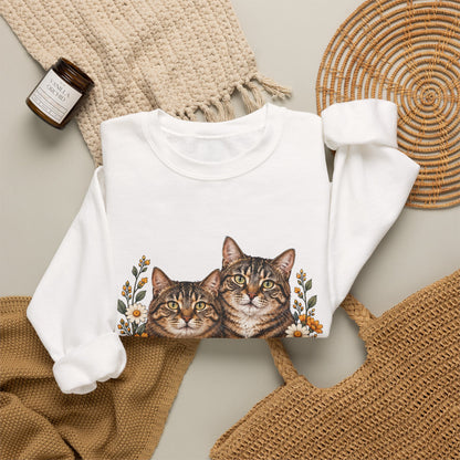Two tabby cats and wildflowers printed on a black unisex crewneck sweatshirt