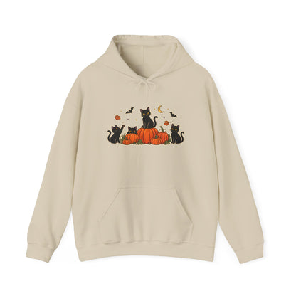 A sand pullover hoodie with a front graphic of black cats sitting on orange pumpkins, surrounded by small bats, leaves, and a crescent moon, shown on a plain white background.