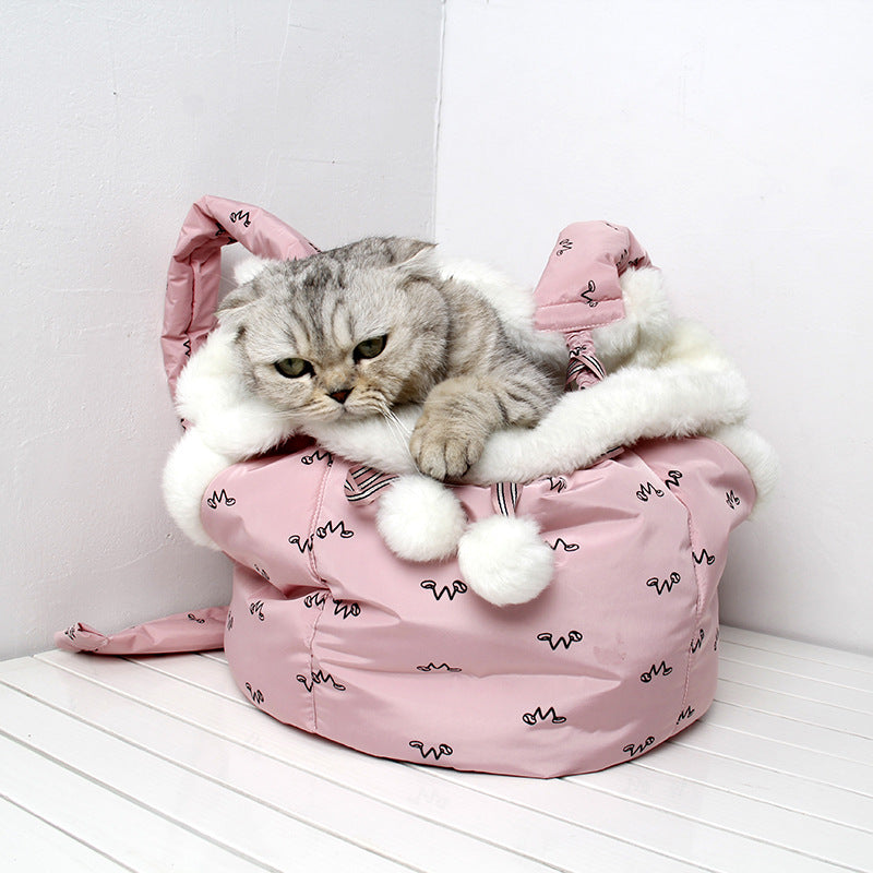 Cat inside a pink bunny-shaped pet bed on a white floor.