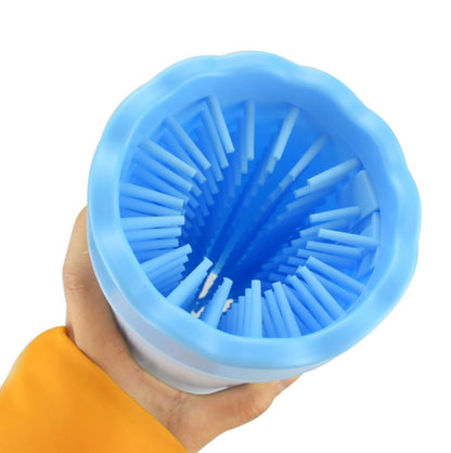 Blue silicone straw holder with straws inside, held by a hand against a white background