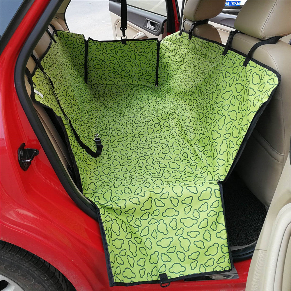 Green pet seat cover with black pattern on a car seat